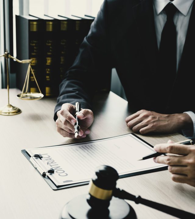 Lawyer hand holding pen and providing legal consult business dispute to the man.